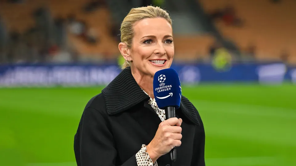 Broadcast presenter reporting pitchside at a Champions League match