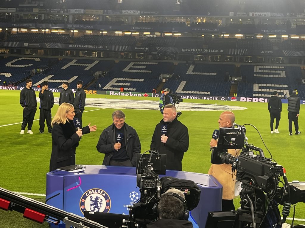 Pundits being interviewed pitchside before a match