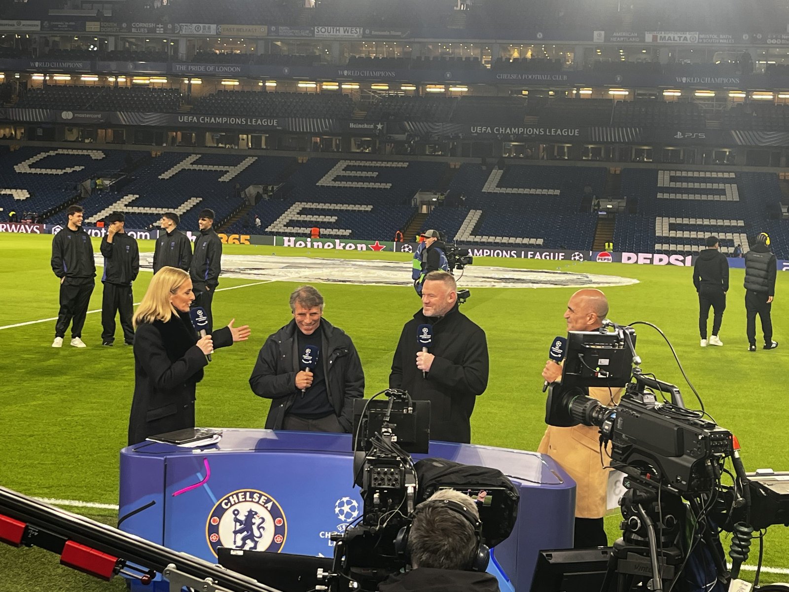 Pundits being interviewed pitchside before a match